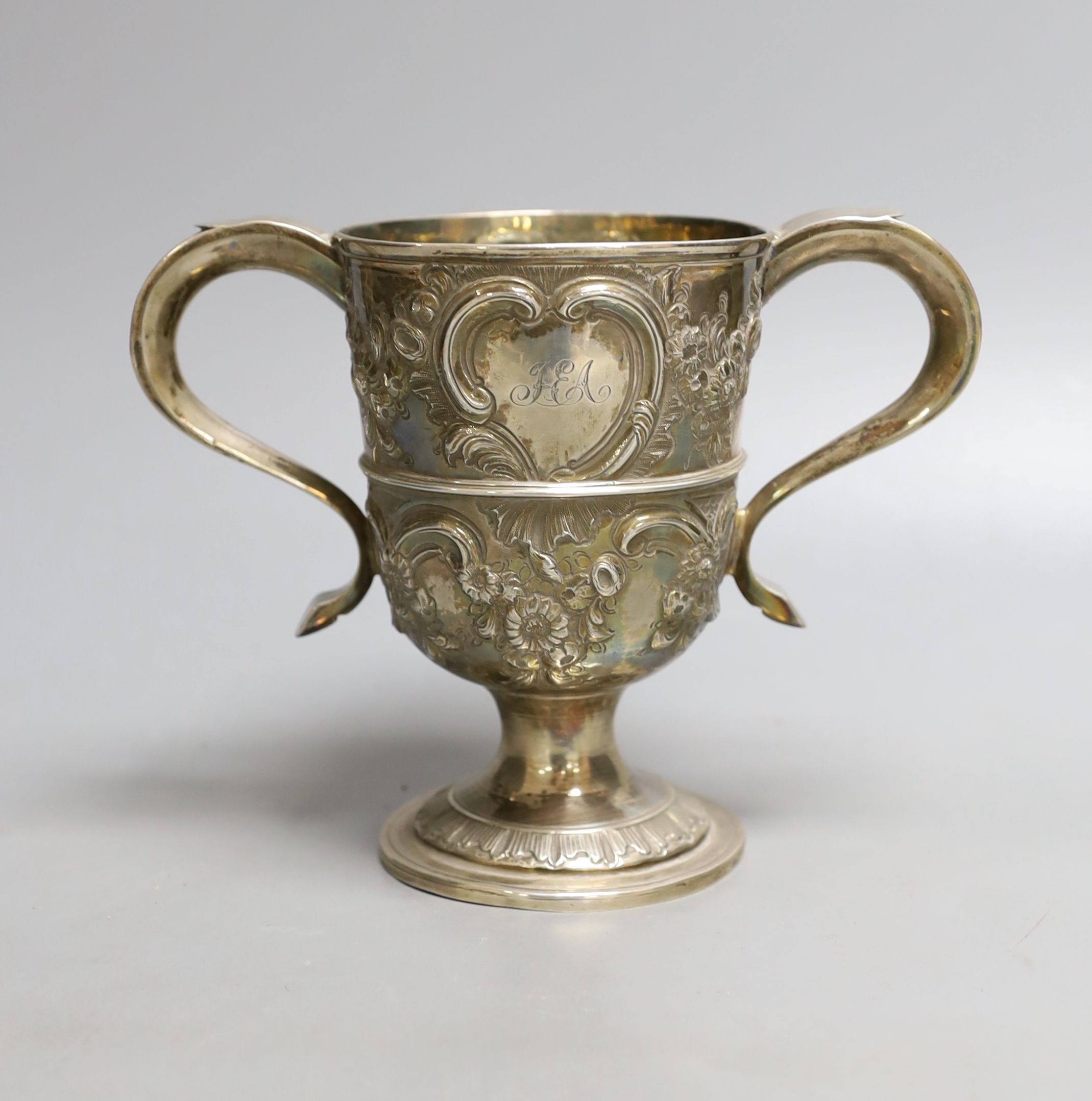 A George III provincial silver two handled pedestal cup, with later embossed decoration, Langlands & Robertson Newcastle, 1794, height 14.7cm, 10.5oz.
